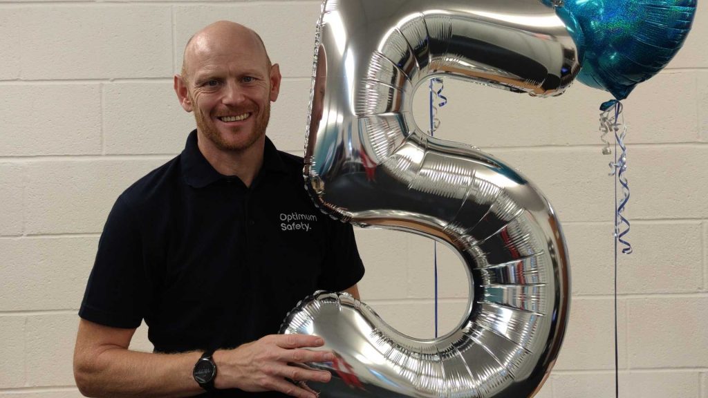 Chris with a big foil 5 balloon