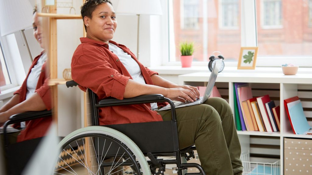 a woman in a wheelchair with a laptop